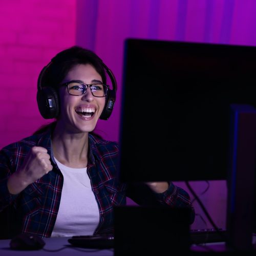 female-gamer-win-game-wearing-headphones-and-rejoicing.jpg